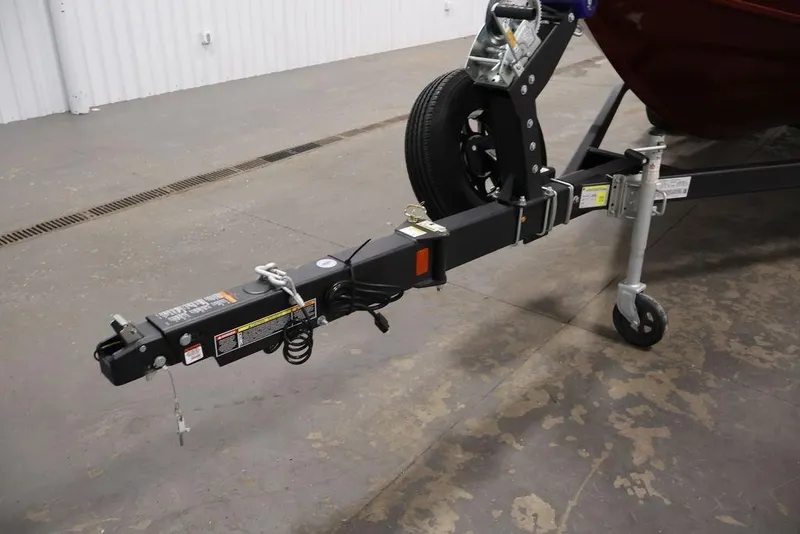 Slide: The Image of Trailer hitch of 2026 Lowe Fishing Machine 1875 boat in a garage setting. - 39