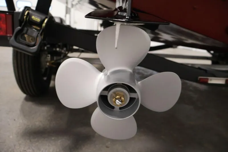 Slide: The Image of 2026 Lowe Fishing Machine 1875 boat propeller close-up in a garage setting. - 40