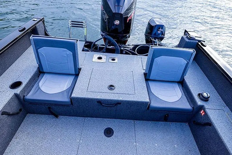 Slide: The Image of 2026 Lowe Fishing Machine 1875 boat interior with two seats and motor on water. - 49