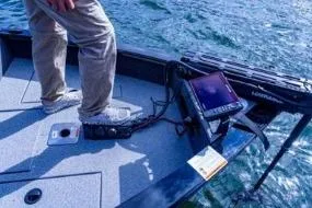 Slide: The Image of 2026 Lowe Fishing Machine 1875 boat in a garage, featuring a sleek red design. - 7