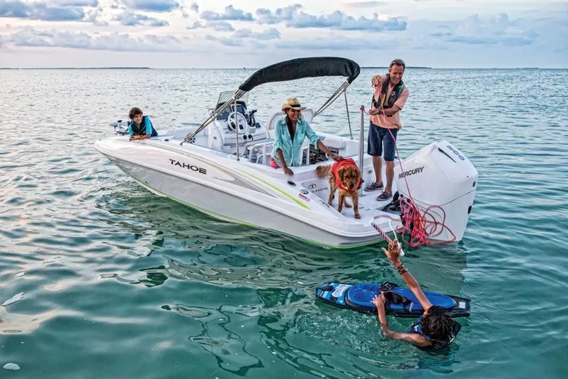 Slide: The Image of 2020 Tahoe 2150 CC boat with people and dog enjoying water activities. - 10