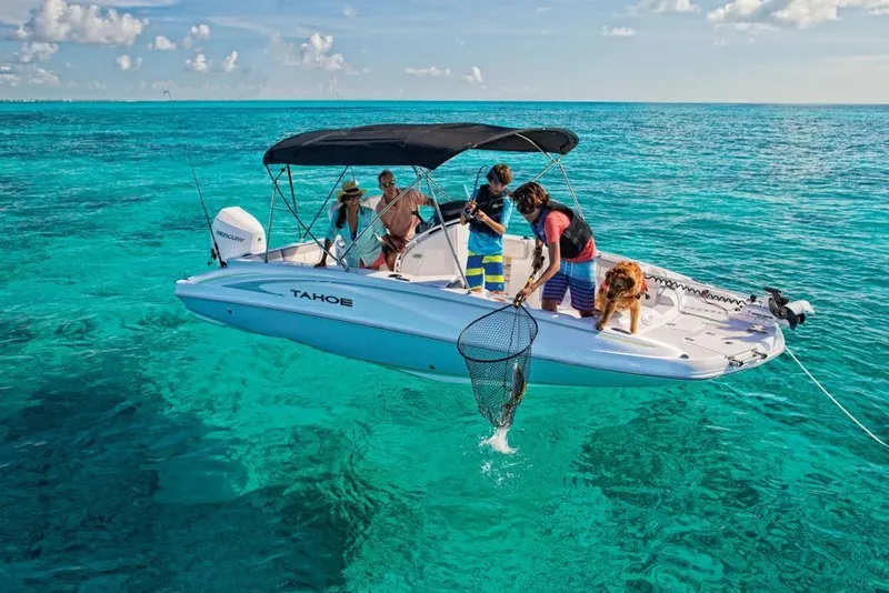 Slide: The Image of 2020 Tahoe 2150 CC boat with people fishing in clear turquoise waters. - 13