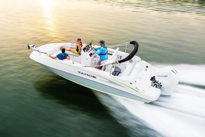 Slide: The Image of 2020 Tahoe 2150 CC boat cruising on water at sunset with passengers. - 15