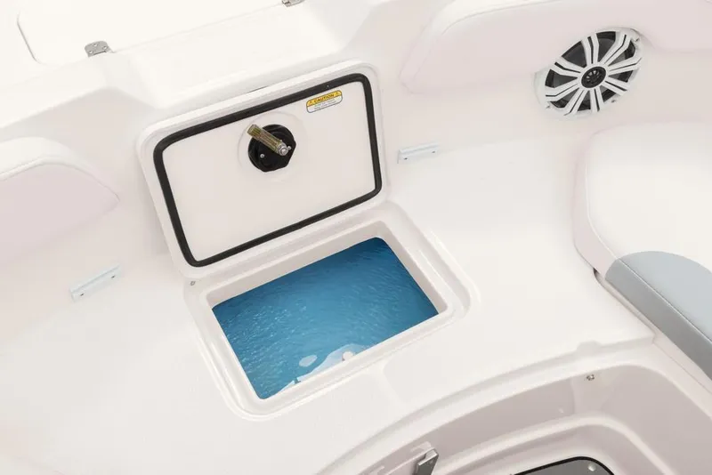 Slide: The Image of 2020 Tahoe 2150 CC boat interior with storage compartment and speaker. - 36