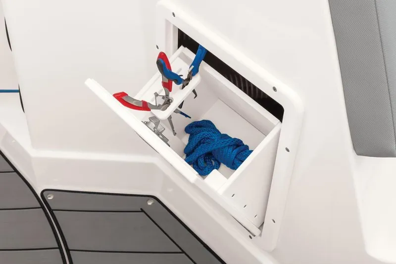Slide: The Image of Storage compartment on 2020 Tahoe 2150 CC boat with tools and blue rope. - 38