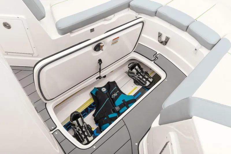 Slide: The Image of 2020 Tahoe 2150 CC boat storage compartment with life jacket and water skis. - 41