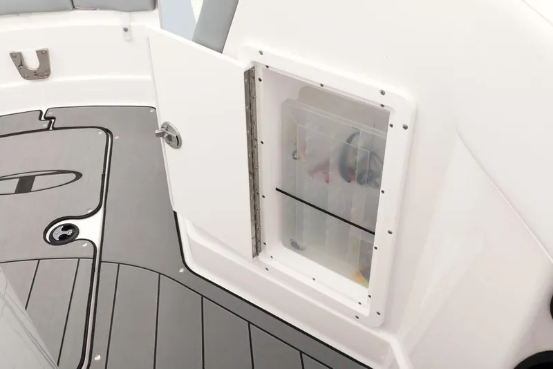 Slide: The Image of 2020 Tahoe 2150 CC boat interior with open storage compartment and sleek flooring. - 43