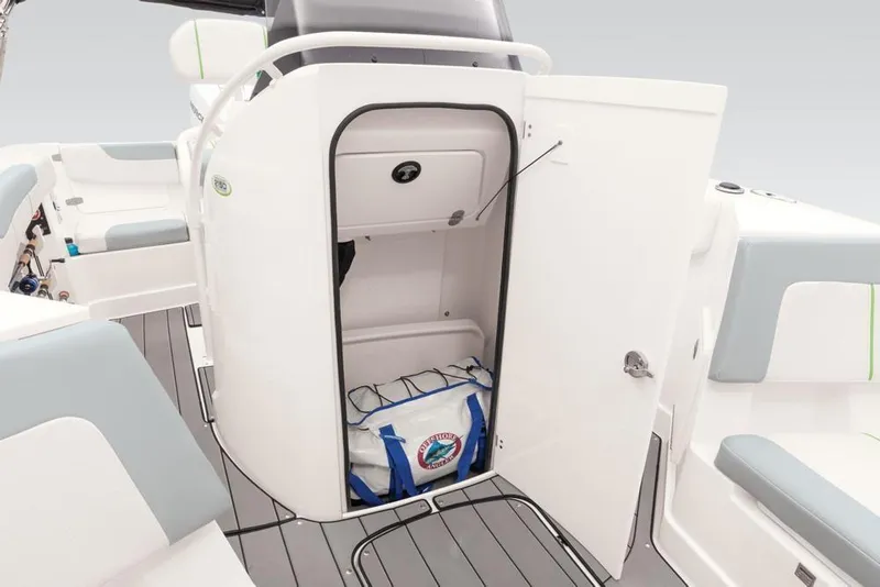 Slide: The Image of 2020 Tahoe 2150 CC boat interior storage compartment with open door and gear bag inside. - 44