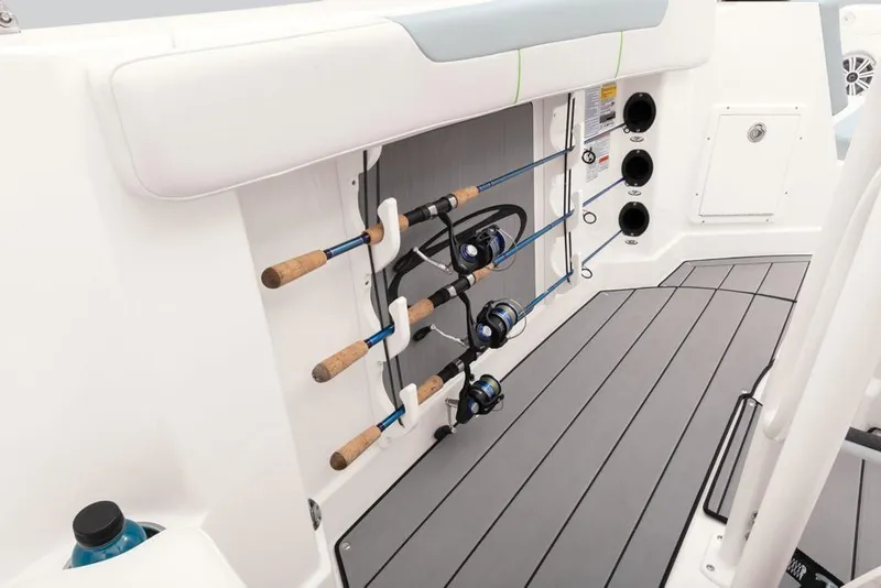 Slide: The Image of 2020 Tahoe 2150 CC boat interior with fishing rod holders and sleek deck design. - 45