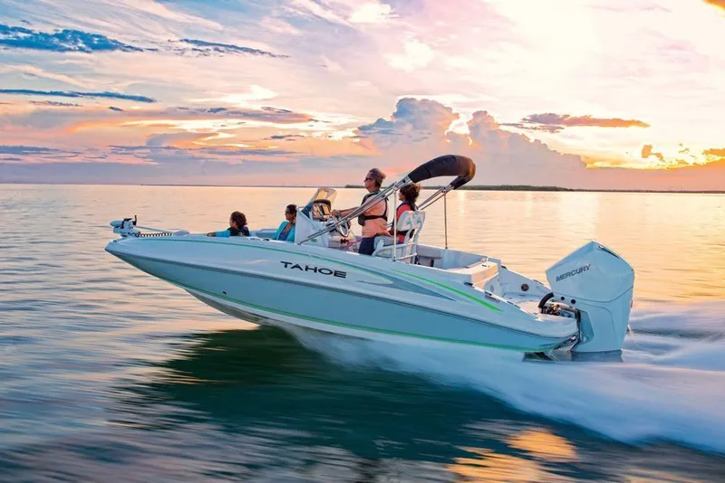 Slide: The Image of 2020 Tahoe 2150 CC boat cruising at sunset on calm waters. - 7