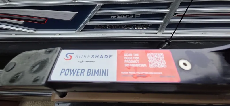 Slide: The Image of 2024 Regency 230 LE3 Sport with SureShade Power Bimini and QR code for product info. - 12