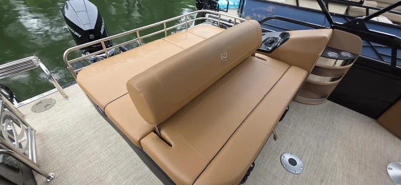 Slide: The Image of 2024 Regency 230 LE3 Sport boat with tan seating and sleek design. - 4