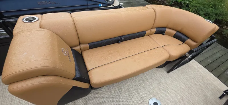 Slide: The Image of Luxurious tan seating on 2024 Regency 230 LE3 Sport boat, featuring sleek design and comfort. - 5