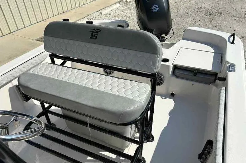 Slide: The Image of 2026 Carolina Skiff 21 LS boat interior with cushioned seating and steering console. - 14