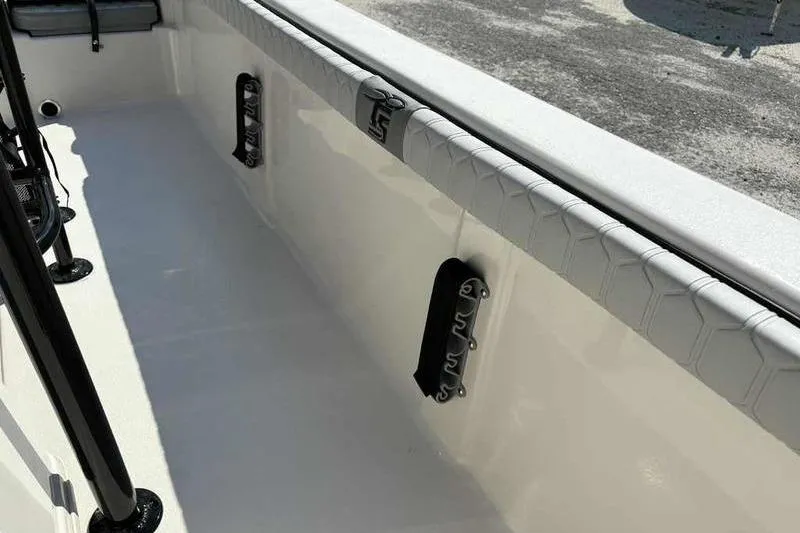 Slide: The Image of 2026 Carolina Skiff 21 LS boat interior with rod holders and cushioned side rail. - 16