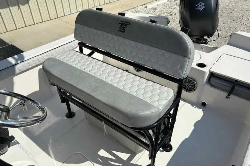 Slide: The Image of 2026 Carolina Skiff 21 LS boat interior with cushioned seating and steering wheel. - 20