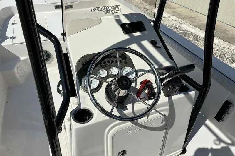 Slide: The Image of 2026 Carolina Skiff 21 LS boat console with steering wheel and gauges. - 23