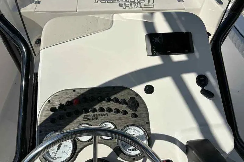 Slide: The Image of 2026 Carolina Skiff 21 LS boat dashboard with steering wheel and control panel. - 4