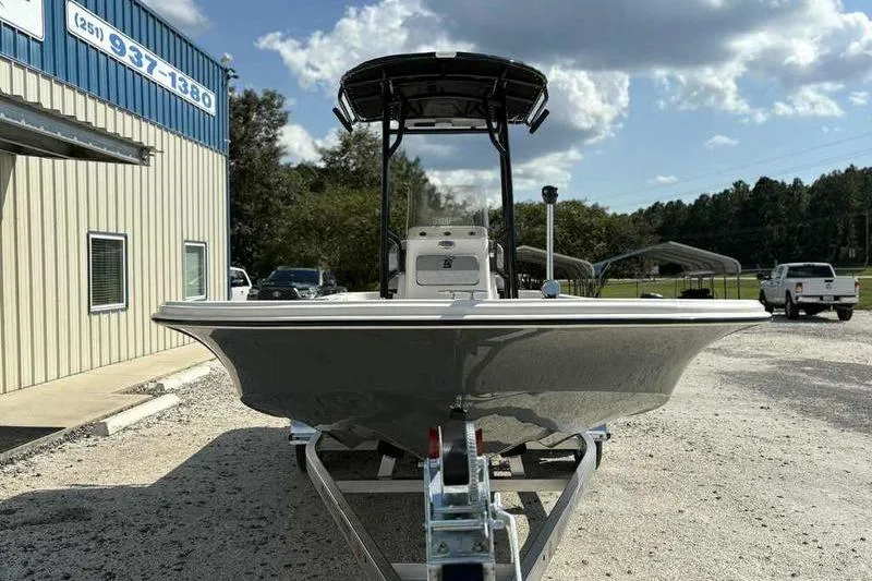 Slide: The Image of 2026 Carolina Skiff 21 LS boat on trailer, parked outside dealership under blue sky. - 6