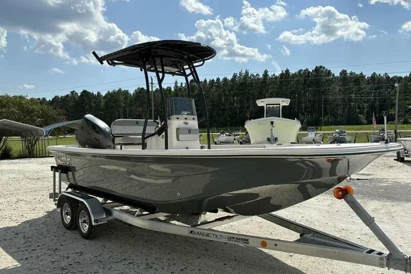 Slide: The Image of 2026 Carolina Skiff 21 LS boat on trailer, parked outdoors under a sunny sky. - 7
