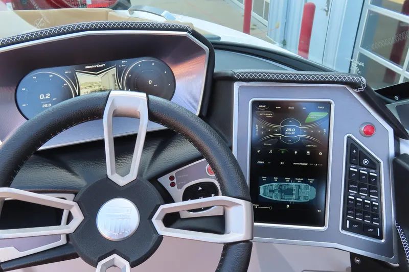Slide: The Image of 2019 MasterCraft X22 dashboard with digital displays and steering wheel. - 15