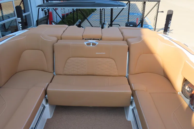 Slide: The Image of 2019 MasterCraft X22 boat with tan leather seating and modern design. - 16