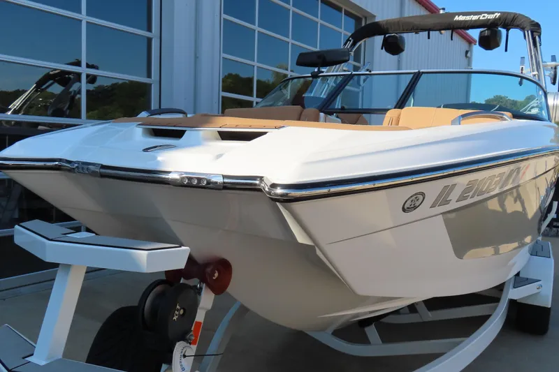 Slide: The Image of 2019 MasterCraft X22 boat on trailer, parked outside a building. - 5