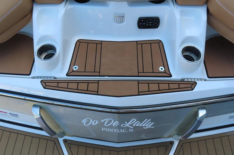 Slide: The Image of 2019 MasterCraft X22 boat stern with teak platform and cup holders, labeled "Oo De Lally." - 7