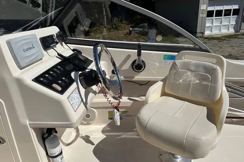 Slide: The Image of 2015 Grady-White Freedom 192 boat cockpit with Garmin navigation system and captain's chair. - 3