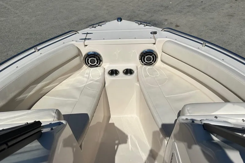 Slide: The Image of 2015 Grady-White Freedom 192 boat interior with white seating and cup holders. - 7