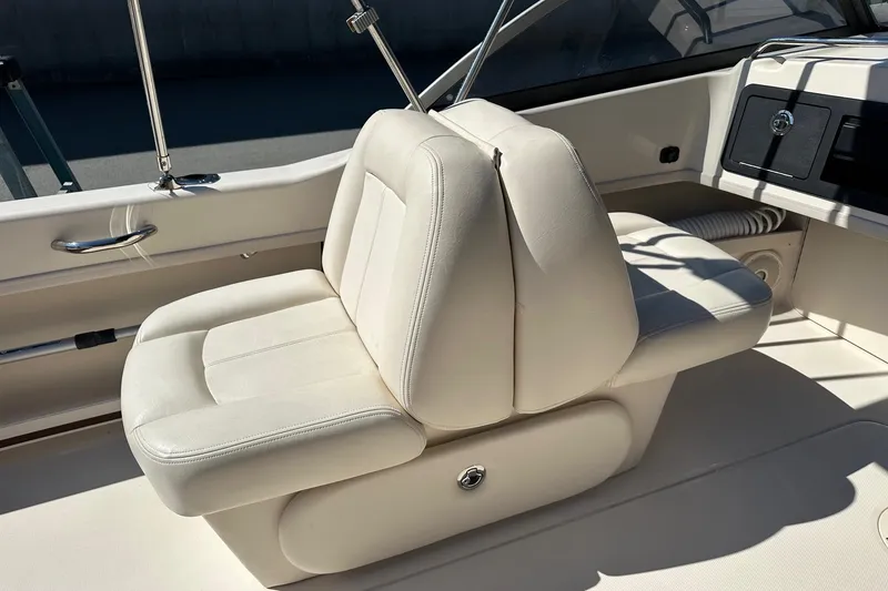 Slide: The Image of 2015 Grady-White Freedom 192 boat interior with white cushioned seating. - 8