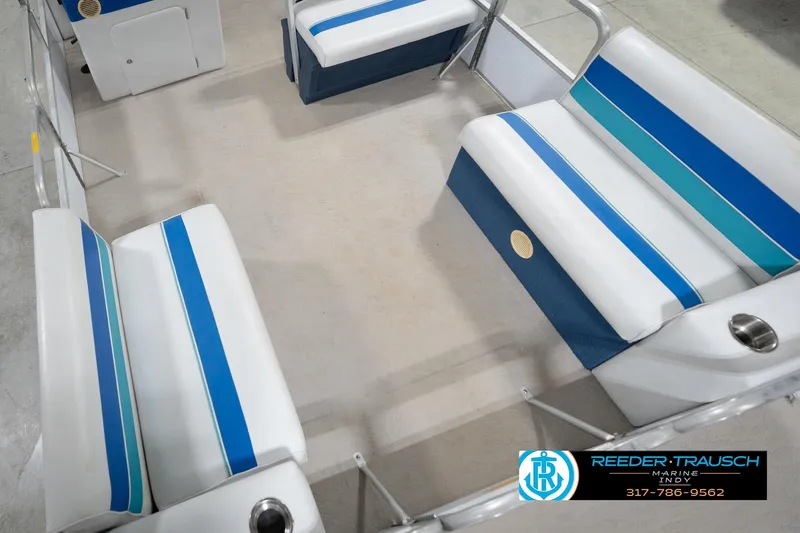 Slide: The Image of 1996 Godfrey Sweetwater 180 EX pontoon boat with blue canopy in indoor showroom. - 12