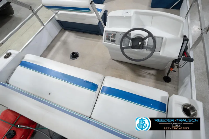 Slide: The Image of Interior of a 1996 Godfrey Sweetwater 180 EX pontoon boat with blue and white seating. - 13