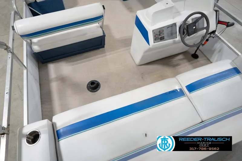 Slide: The Image of 1996 Godfrey Sweetwater 180 EX boat interior with blue and white seating, Reeder-Trausch Marine logo. - 14