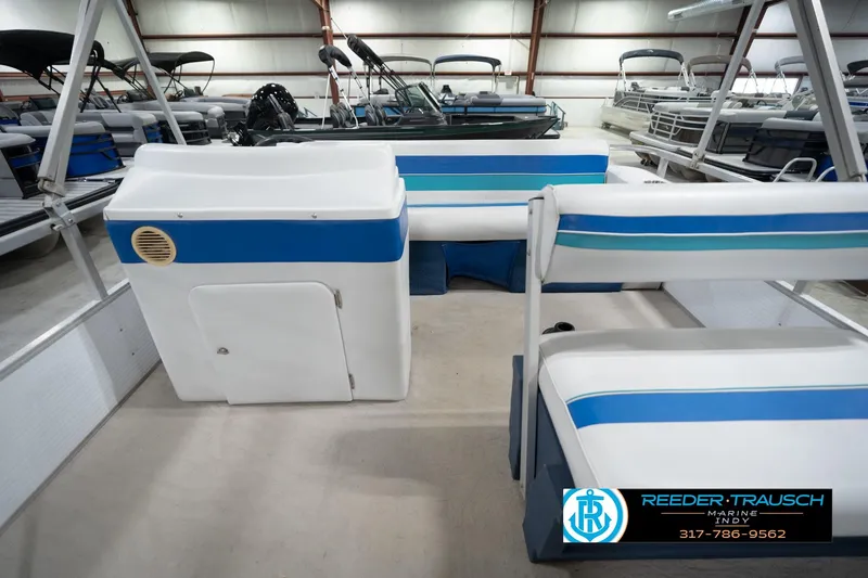 Slide: The Image of 1996 Godfrey Sweetwater 180 EX boat interior with blue and white seating and steering console. - 16