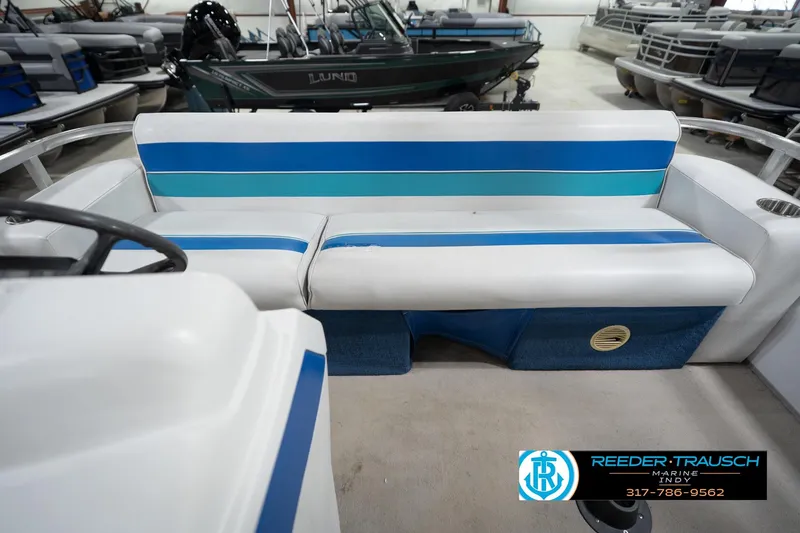 Slide: The Image of 1996 Godfrey Sweetwater 180 EX pontoon boat interior with blue and white seating. - 17