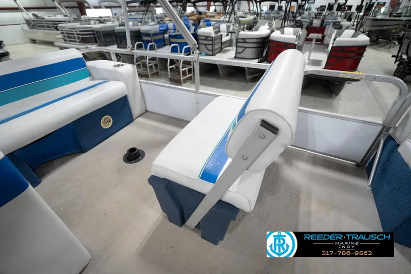 Slide: The Image of 1996 Godfrey Sweetwater 180 EX pontoon boat interior with blue and white seating. - 24