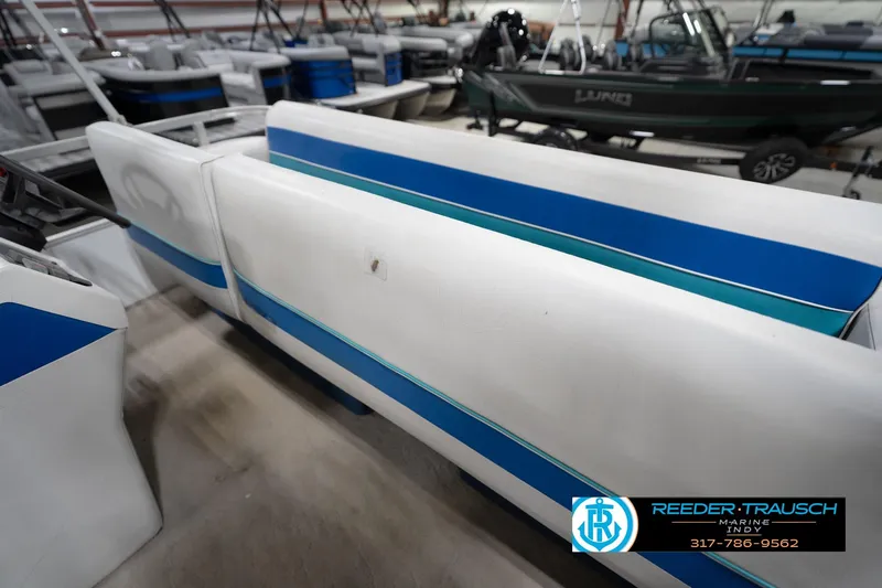 Slide: The Image of 1996 Godfrey Sweetwater 180 EX pontoon boat interior with blue and white seating. - 26