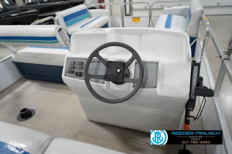 Slide: The Image of 1996 Godfrey Sweetwater 180 EX boat interior with blue and white seating. - 27