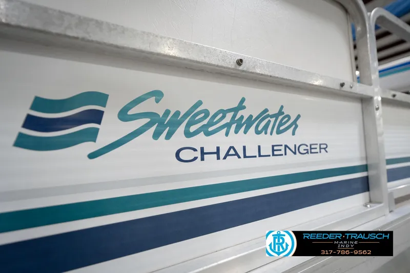 Slide: The Image of 1996 Godfrey Sweetwater 180 EX boat motor in a showroom, featuring Reeder-Trausch Marine logo. - 41