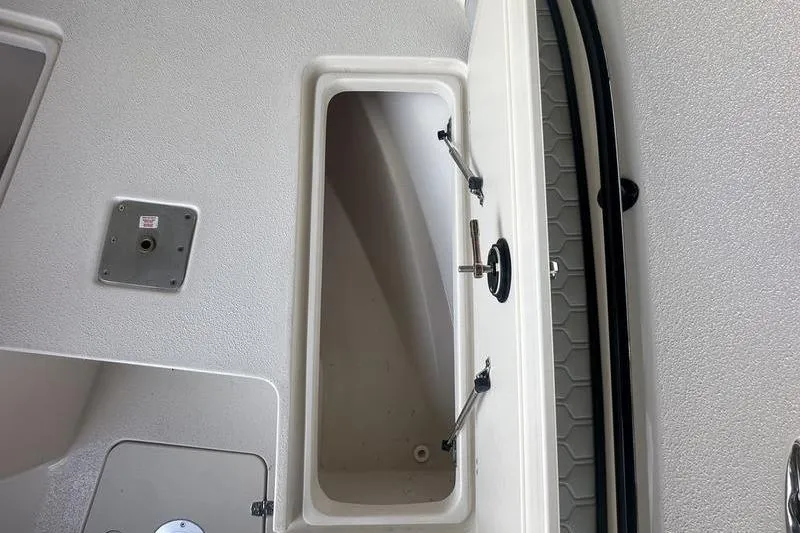 Slide: The Image of 2026 Carolina Skiff 24 Ultra Elite boat storage compartment, open and empty. - 10