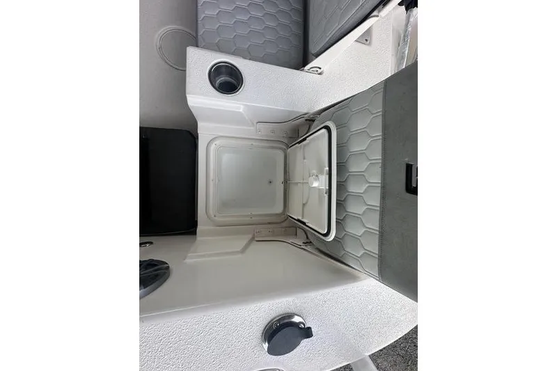 Slide: The Image of 2026 Carolina Skiff 24 Ultra Elite boat interior with open storage compartment. - 16
