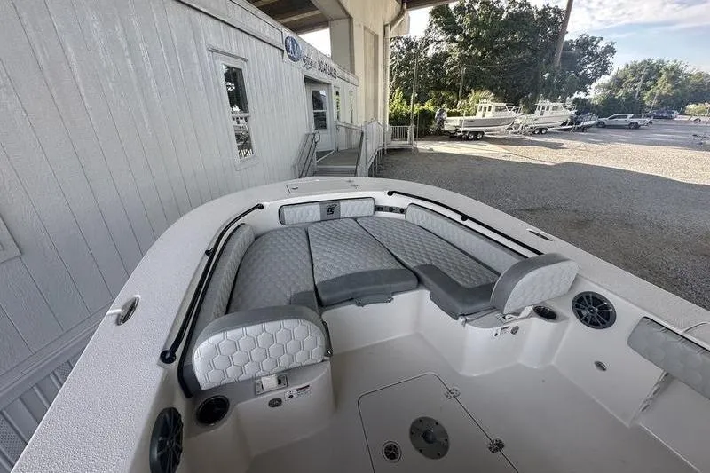 Slide: The Image of 2026 Carolina Skiff 24 Ultra Elite boat interior with cushioned seating and speakers. - 3