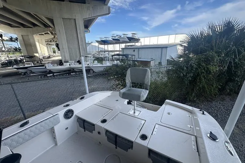 Slide: The Image of 2026 Carolina Skiff 24 Ultra Elite boat interior with seating and storage compartments. - 7