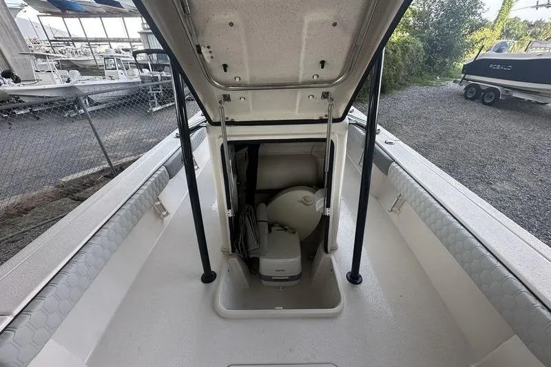 Slide: The Image of 2026 Carolina Skiff 24 Ultra Elite boat with open storage compartment. - 8