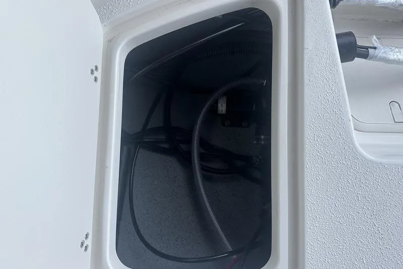 Slide: The Image of Storage compartment of 2026 Carolina Skiff 24 Ultra Elite boat, showing internal wiring. - 9