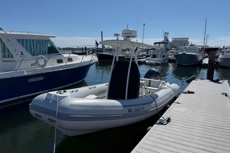 Slide: The Image of 2020 AB Inflatables Oceanus 21 VST docked at a marina, surrounded by boats. - 24