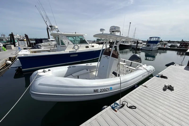 Slide: The Image of 2020 AB Inflatables Oceanus 21 VST boat docked at marina, clear sky background. - 2