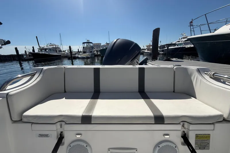 Slide: The Image of 2020 AB Inflatables Oceanus 21 VST boat at marina, featuring rear seating and motor. - 12