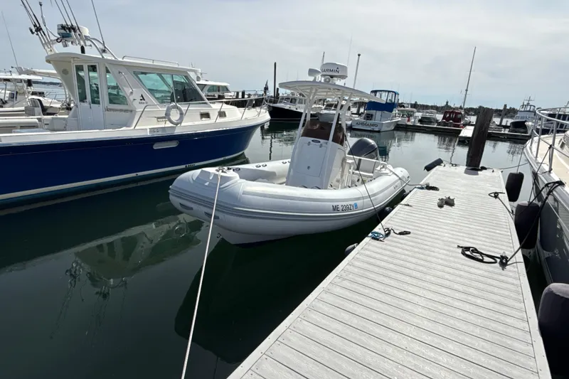 Slide: The Image of 2020 AB Inflatables Oceanus 21 VST docked at a marina, surrounded by other boats. - 1